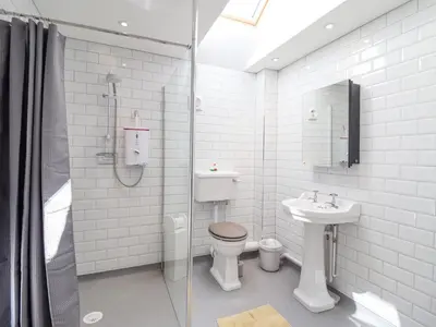 a bathroom with a toilet and a sink and a shower at Varley Villa in Newtown