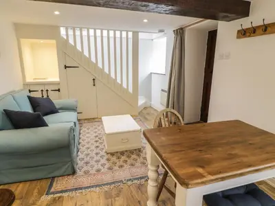 a living room with a couch and a table at Gelli Bach at Gelli Las in Llanbedr