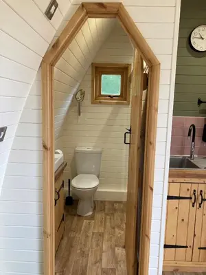 a bathroom with a toilet and a sink at Delor - Bryntalch Glamping Pods in Montgomery
