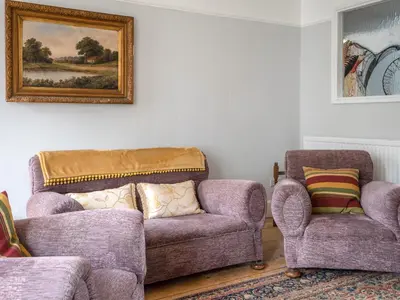 a living room with two chairs and a couch at Galeri Harlech Townhouse in Harlech