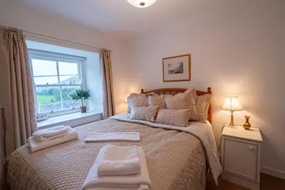 a bedroom with a bed with two towels on it at Ty Canol Maentwrog, Snowdonia Nr Zip World in Maentwrog