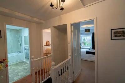 a hallway with a staircase leading to a bedroom at Ty Canol Maentwrog, Snowdonia Nr Zip World in Maentwrog