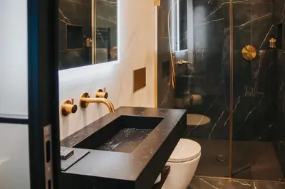 a bathroom with a black sink and a shower at Y Seler in Aberaeron