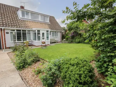 a house with a yard with a lawn at Roseland in Ludlow