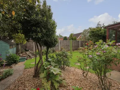 a garden with trees and flowers in a yard at Roseland in Ludlow