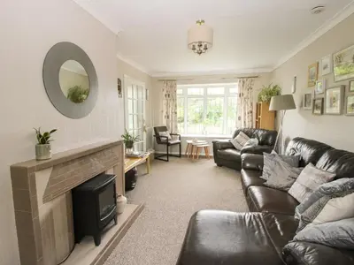 a living room with a couch and a fireplace at Roseland in Ludlow