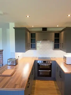 a kitchen with a wooden counter top in a kitchen at 3 Bedroom Bungalow in Llanrhaeadr Ym in Oswestry
