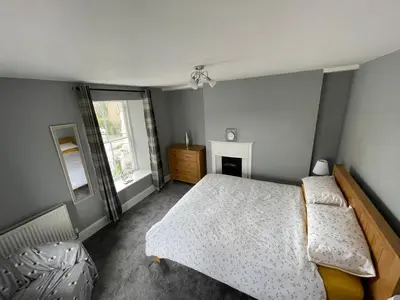 a bedroom with a bed and a window at The Bala House in Bala