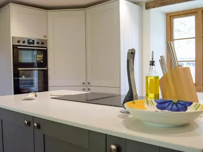 a kitchen with a counter with a bowl on it at Lower Goytre Farmhouse in Llanvair Waterdine