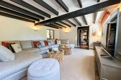 a living room with a couch and a tv at Marrington Mill in Chirbury
