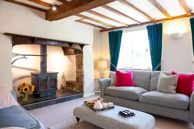 a living room with a couch and a wood stove at Marrington Mill in Chirbury