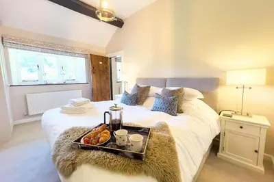a bedroom with a bed with a tray of food on it at Marrington Mill in Chirbury
