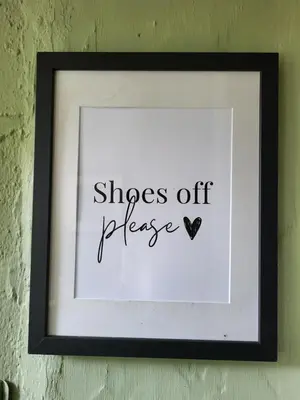 a framed picture with the words shoes off please at The Green Door Vegan B&B in Llanon