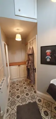 a room with a hallway with a door and a rug at Cosy Spring Cottage at Pen Y Coed Hall in Dolgellau