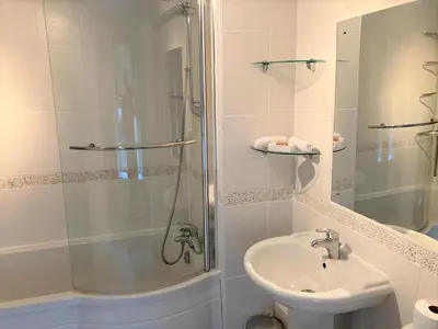a bathroom with a shower and a toilet and a sink at Glasfryn Cottage Dolgellau in Dolgellau