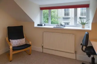a room with a chair and a radiator and a window at Glasfryn Cottage Dolgellau in Dolgellau