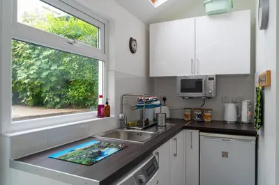 a kitchen with a sink and a window at Glasfryn Cottage Dolgellau in Dolgellau
