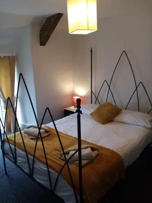 a bedroom with a large bed in a room at Bridge View Victorian Townhouse Central Aberystwyth Sleeps 6 in Aberystwyth