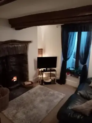a living room with a couch and a tv and a fireplace at Bridge View Victorian Townhouse Central Aberystwyth Sleeps 6 in Aberystwyth