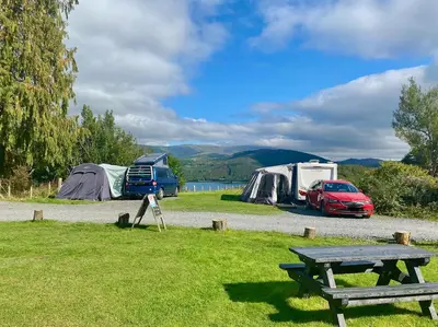 a group of tents and a picnic table in a field at Empress En Suite Wagon in Arthog