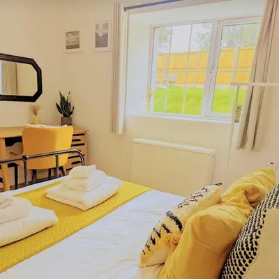 a bedroom with a bed with two towels on it at Bryngwalia Fach in Cribyn
