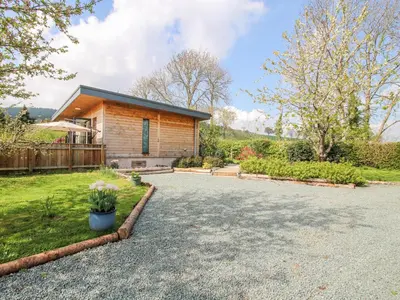 a house with a driveway in front of it at No1 The Lodge in Bishops Castle
