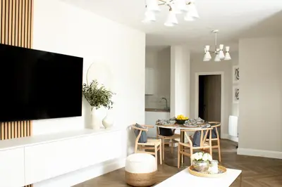 a living room with a large flat screen tv on a wall at John Lewis Apartment in Aberaeron