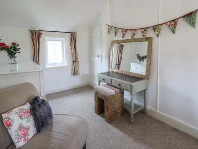 a living room with a mirror and a dressing table at Bryniau Bychain Cottage in Machynlleth
