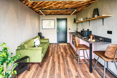 a living room with a couch and a table at Rusty Boathouse in Llanarth