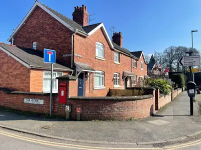 a brick house with a street sign in front of it at Old Street Terrace in Ludlow
