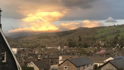 a view of a town with a mountain at Bryn Mair Gardens in Dolgellau