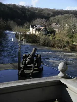 a gun on the bow of a boat on a river at The Charlton Arms in Ludlow
