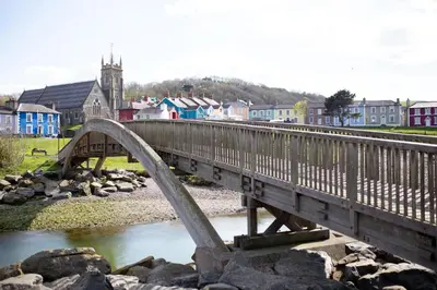 a bridge over a river with a town in the background at Richardson Apartment in Aberaeron