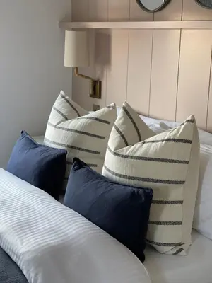 a group of pillows sitting on a bed at Salthouse apartment in Aberaeron