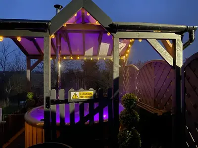 a gazebo with a warning sign and a barrel at Cherry Pod in Shrewsbury