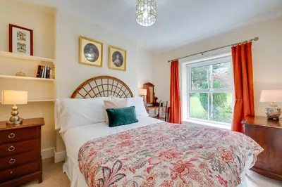 a bedroom with a large bed and a window at 4 Bed in Machynlleth oc-wad350 in Cemmaes
