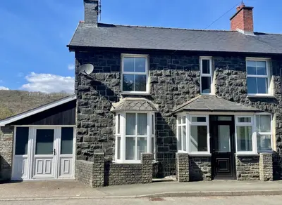a stone house with white doors and windows at 4 Bed in Machynlleth oc-wad350 in Cemmaes