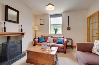 a living room with a couch and a fireplace at 4 Bed in Machynlleth oc-wad350 in Cemmaes