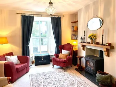 a living room with a chair and a fireplace at 4 Bed in Machynlleth oc-wad350 in Cemmaes