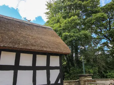 a roof of a building with trees in the background at Manor Cottage in Church Stretton