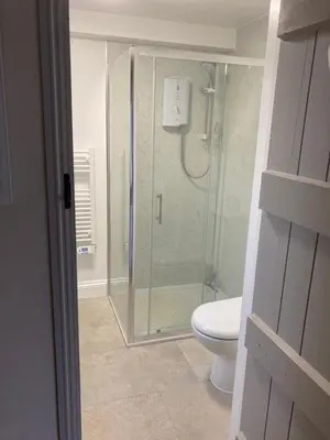 a glass shower in a bathroom with a toilet at The Cedars Ludlow in Lane to Richards Castle