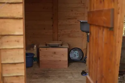 an inside view of a wooden room with a stove at MotoCamp Wales -Camping Pods in Dolgellau