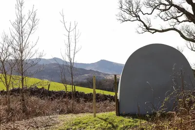 a circular object sitting on the side of a field at MotoCamp Wales -Camping Pods in Dolgellau