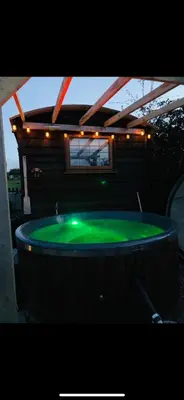a large green pool with lights on top of it at Four seasons with wood fuel hot tub Country retreat in Hereford