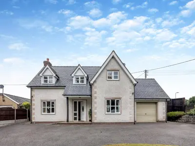a large white house with a garage at Cysgod Y Capel in Cerrigydrudion