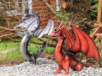 a red dragon and a silver dragon on some rocks at Ty Coed - 63 in Trawsfynydd