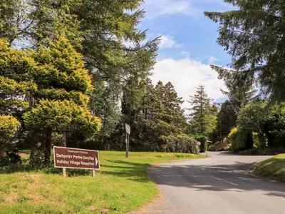 a sign in the grass next to a road at Ty Coed - 63 in Trawsfynydd