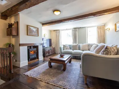a living room with a couch and a fireplace at Turford House in Ludlow