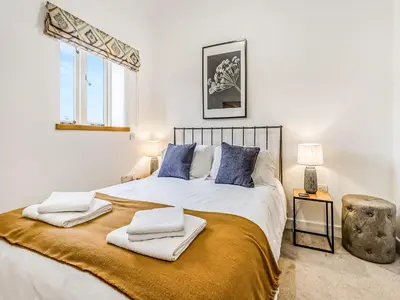 a bedroom with a large bed with towels on it at Mouse Croft - Uk33954 in Llanymynech