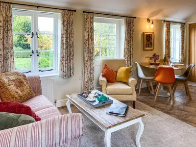 a living room with a couch and a table at The Bothy - Uk33692 in Bicton